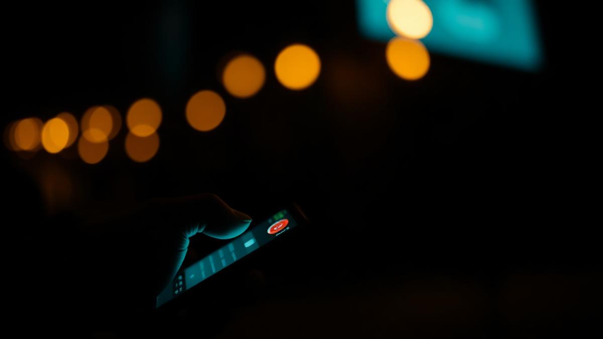 Smartphone lighting up with an after-hours customer call at night