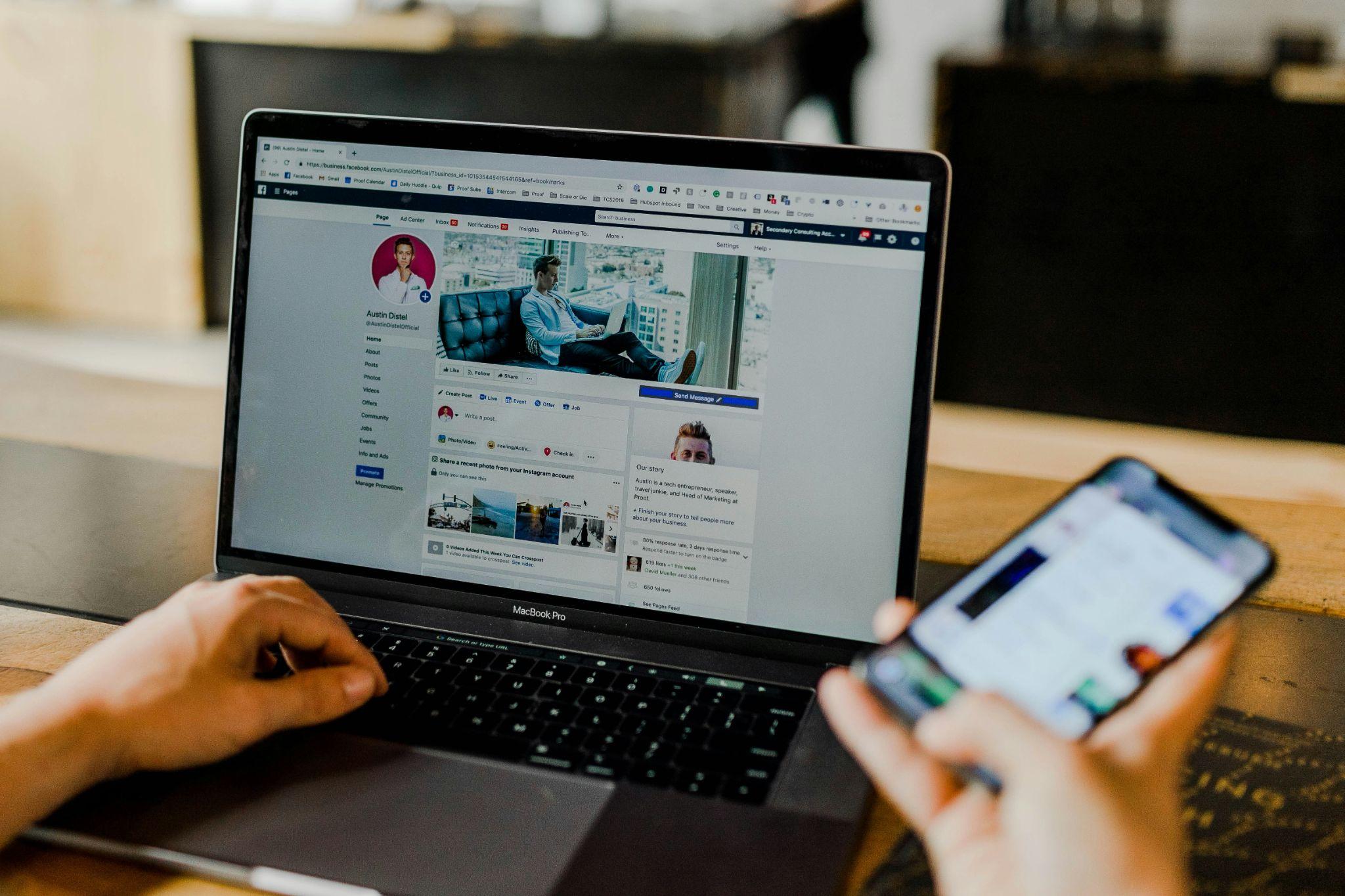 A business owner manages a social media page on a laptop and smartphone, supporting lead generation in California.