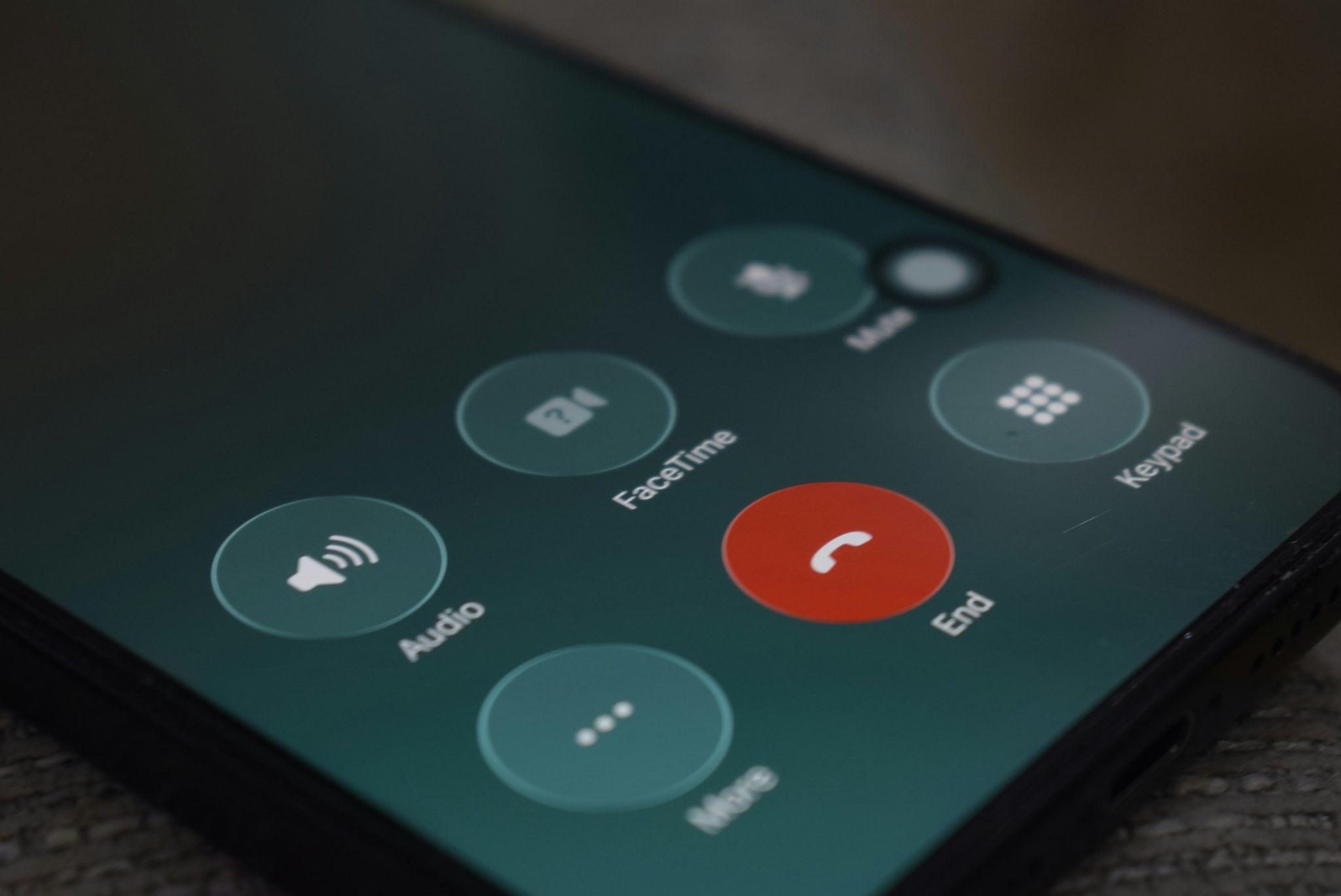 A close-up of an active phone call highlights missed call text back for businesses in California.
